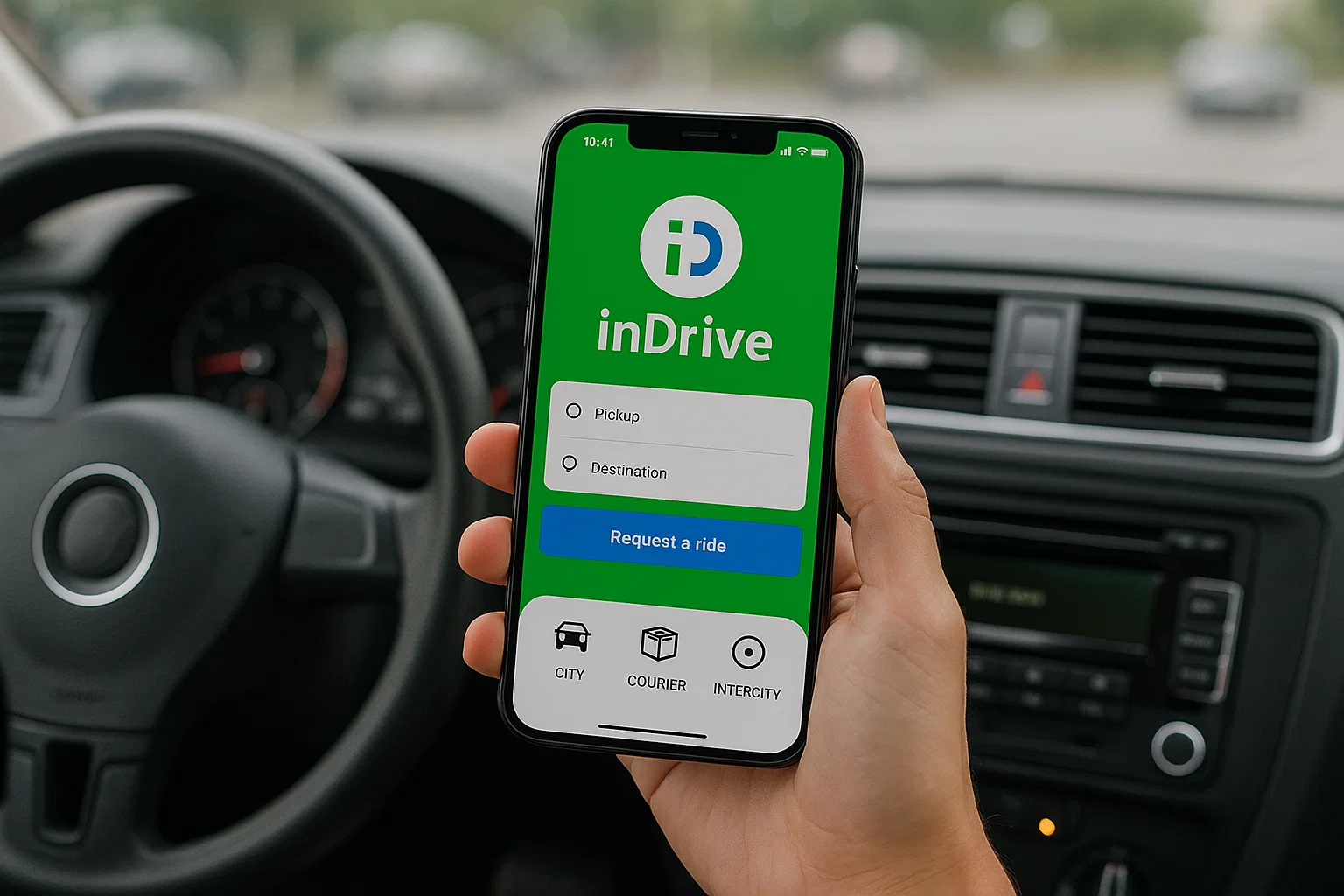 Hand holding a smartphone displaying the inDrive ride-hailing app interface with pickup and destination input fields and a “Request a ride” button, inside a car.