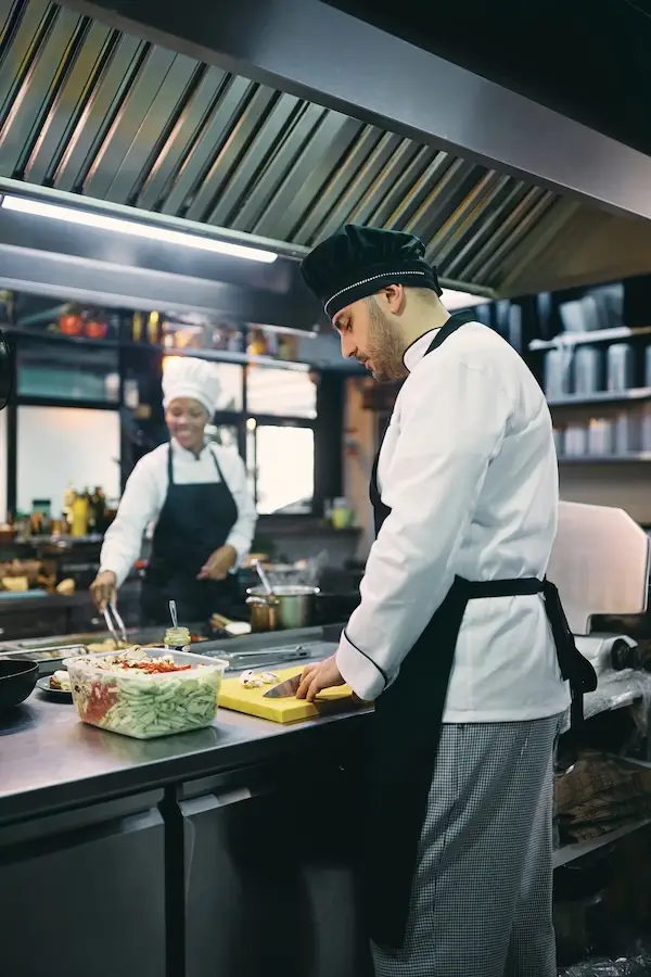 Chef preparing ingredients in a professional kitchen
